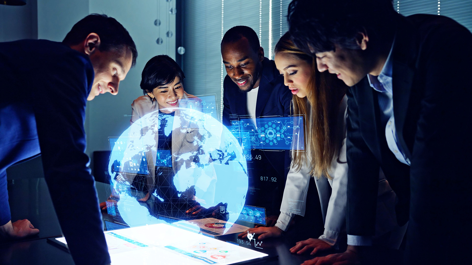 Team collaborating around a digital display