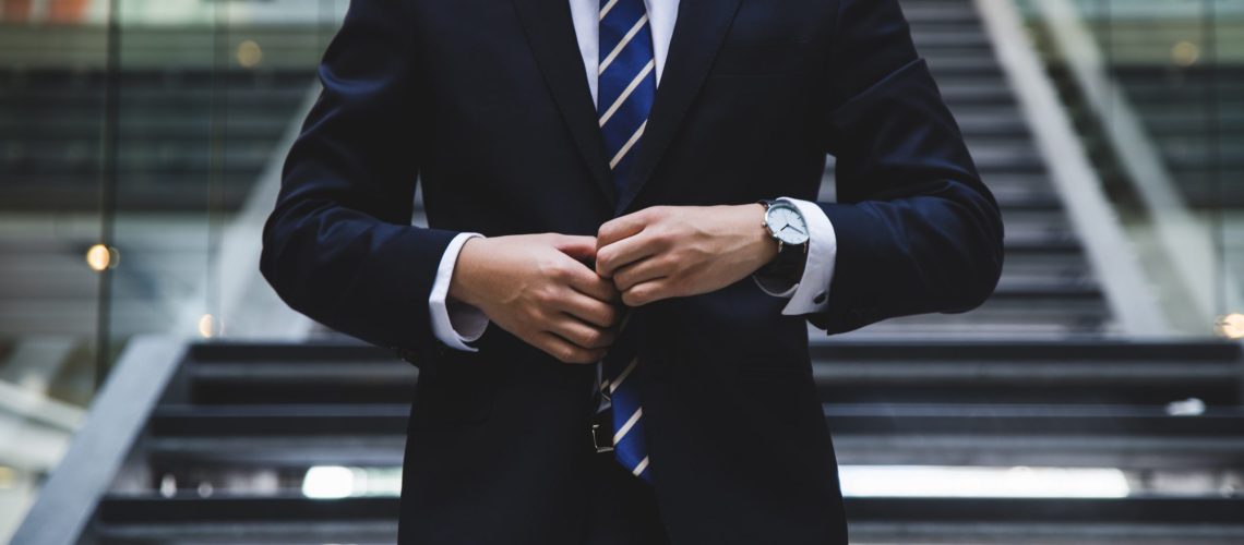 Executive in business attire outside a modern office